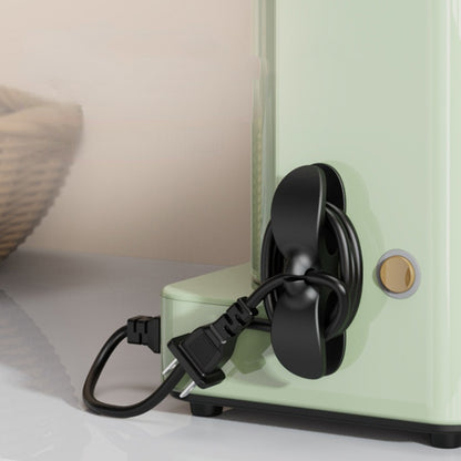 Appliance cord organizer attached to a kitchen appliance